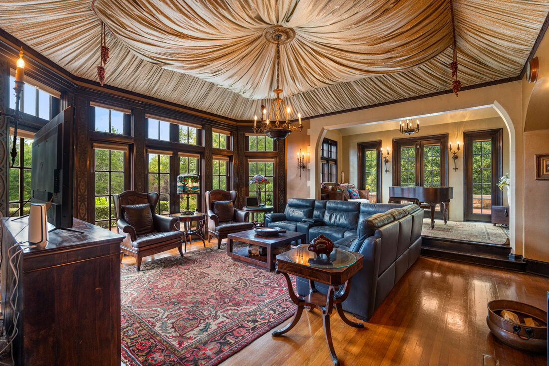 Great room with a wall of windows overlooking the grounds